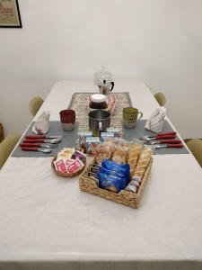 a table with a white table cloth with food on it at S'Agapò in Torre del Greco