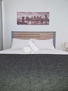 a bedroom with a bed with two towels on it at Grace Avenue Bungalow in Port Edward