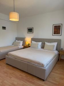 two beds in a room with white walls at The Korčula Outlook - Bedrooms in Korčula