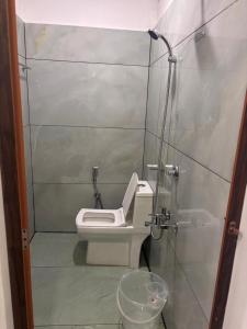 a small bathroom with a toilet in a stall at Mount Elbrus Home stay in Devikolam