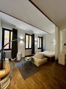 a living room with a bed and a couch at Residenza Corrado in Mantova