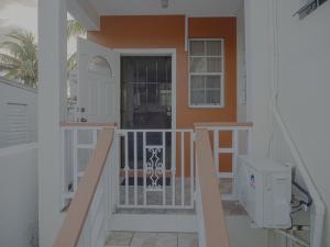 a staircase leading up to a house with a door at Getaway Homes in Basseterre