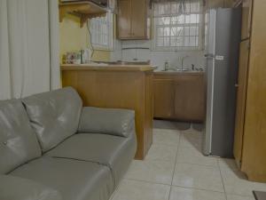 a living room with a couch and a kitchen at Getaway Homes in Basseterre