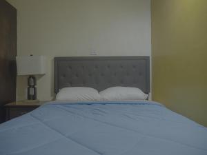 a bedroom with a large bed with a blue blanket at Getaway Homes in Basseterre