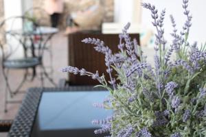 a vase of purple flowers sitting on top of a table at SunΚissed Home - Pollonia Milos in Pollonia