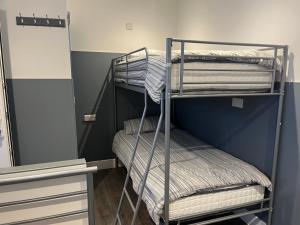 a bunk bed room with three bunk beds at Townsend lane accommodation in Liverpool