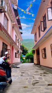 an alley between two buildings with a car parked next to it at Hotel lalu in Rāmechhāp +12 photos