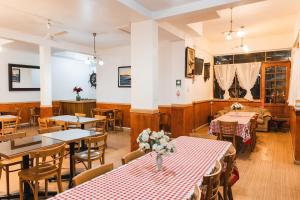 a restaurant with tables and chairs in a room at Hotel Montecarlo in Caldera +23 photos