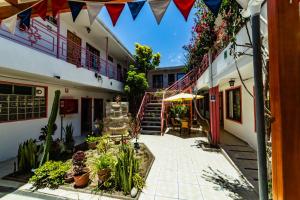 a courtyard of a building with plants and a staircase at Hotel Montecarlo in Caldera