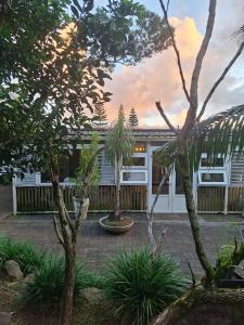 a house with a courtyard with trees and a fence at Pieter Both Mountain Lodge in La Laura