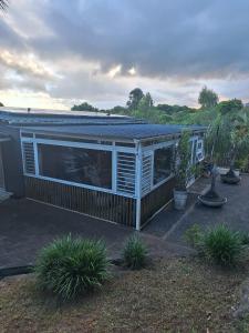 a house with a blue roof and some plants at Pieter Both Mountain Lodge in La Laura