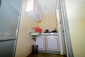 a small kitchen with a sink and a sink at Maurine Homestays in Eldoret +5 photos