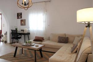 a living room with a couch and a table at SunΚissed Home - Pollonia Milos in Pollonia