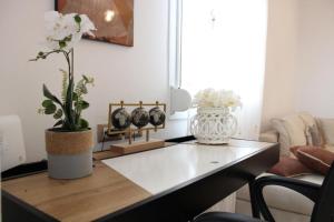 a living room with a table with flowers on it at SunΚissed Home - Pollonia Milos in Pollonia +48 photos