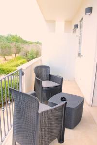 a patio with chairs and a table on a balcony at LA BELLA DIMORA in Otranto