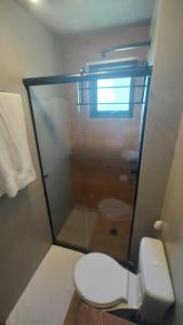 a bathroom with a toilet and a glass shower at Cabana Cambará in Cambará +76 photos