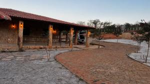 a building with a brick walkway in front of it at Recanto do tdias in Mulungu