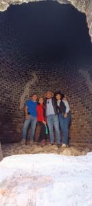 a group of people standing in a brick tunnel at Cuanax hotel boutique tematico - Mineral de Pozos in Mineral de Pozos