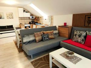 a living room with a couch and a table at Apartmán Romanna in Terchová