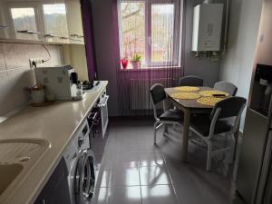 a kitchen with a table and a table and a dining room at Thaleia Retreat in Ocna-Mureşului +12 photos