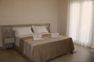 a bedroom with a bed with two towels on it at LA BELLA DIMORA in Otranto