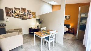a small living room with a table and a bedroom at Les Gîtes du Domaine de Ludeye in Listrac-Médoc +6 photos