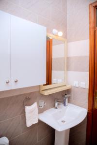 a bathroom with a sink and a mirror at Quiet Home Apartment in Kigali +29 photos