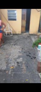 a person standing in a yard next to a building at Casa em Bezerros in Bezerros