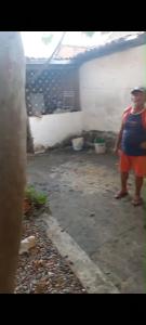 a man is standing in a garage at Casa em Bezerros in Bezerros