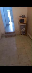 a small kitchen with a window and a microwave at Casa em Bezerros in Bezerros