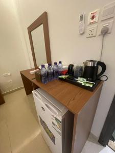 a counter with bottles of water on top of a refrigerator at شقير للغرف الفندقية 1 in Medina