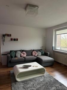 a living room with a couch and a table at Bright & Spacious 1BR Apartment in Bielefeld