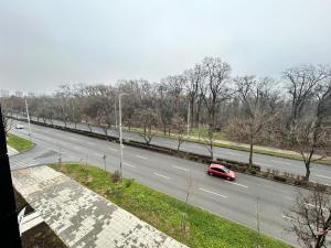 a red car is driving down a highway at Le bijou Lauta Forest in Plovdiv