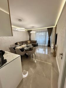 a kitchen and living room with a table and a couch at Le bijou Lauta Forest in Plovdiv