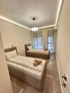 a bedroom with two beds and a mirror at Le bijou Lauta Forest in Plovdiv