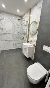 a bathroom with a toilet and a sink and a mirror at Le bijou Lauta Forest in Plovdiv
