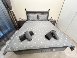 a bedroom with a bed with polka dot sheets and pillows at Le bijou Lauta Forest in Plovdiv +13 photos