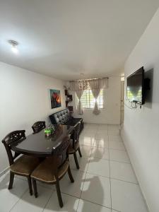 a dining room and living room with a table and chairs at Cozy house in Dosquebradas in Dosquebradas