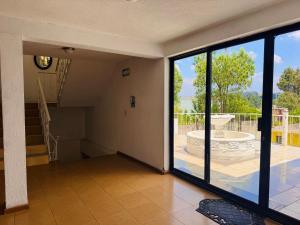 an empty room with a large window and a staircase at Hotel Hacienda Real, Villa in Villa del Carbón