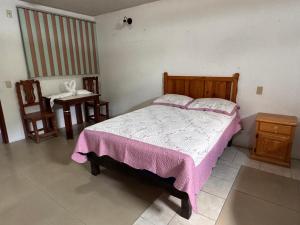 a bedroom with a bed and a table and chairs at Hotel Hacienda Real, Villa in Villa del Carbón +8 photos