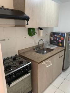 a kitchen with a sink and a stove at Cozy house in Dosquebradas in Dosquebradas