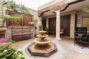 a courtyard with a fountain in the middle of a building at Arte Vida Suites & Spa in Granada
