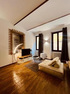 a large living room with a bed and a television at Residenza Corrado in Mantova