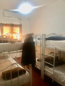 a room with three bunk beds in a room at Hostel Base La Rioja in La Rioja +6 photos