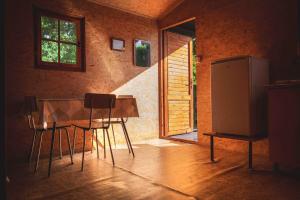 a kitchen with a table and chairs and a window at Kemp Selská rokle in Doksy +18 photos