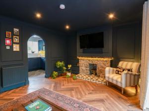 a living room with a fireplace and a tv at 7 Brewery Pool in Newton Stewart