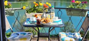 a table with a breakfast of croissants and pastries at LES PINGOUINS DE LA MARNE in Le Perreux-Sur-Marne