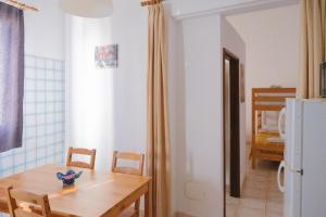 a dining room with a table and a refrigerator at La Palma Hostel by Pension Central in Fuencaliente de la Palma