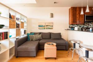 a living room with a couch and a kitchen at Studio nr Town Lake and E6th w Balcony by Austin Vacay in Austin
