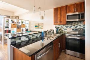 a kitchen with a sink and a stove at Studio nr Town Lake and E6th w Balcony by Austin Vacay in Austin